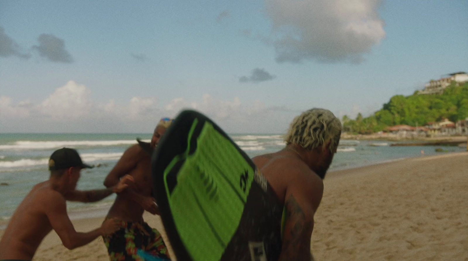 a couple of men standing next to each other on a beach