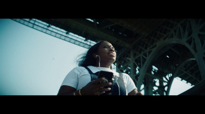 a woman holding a cell phone in front of the eiffel tower