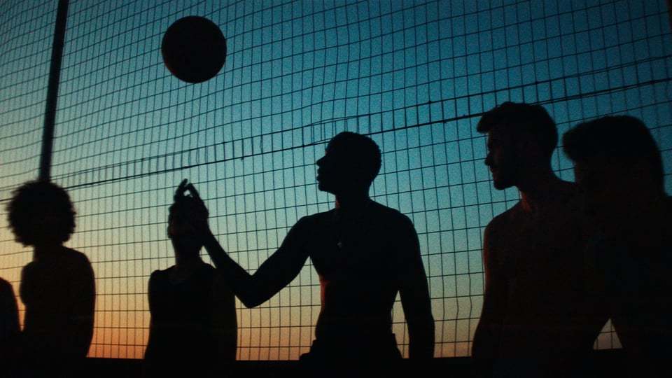 a group of people standing next to each other near a net