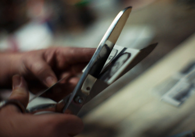 a close up of a person holding a pair of scissors