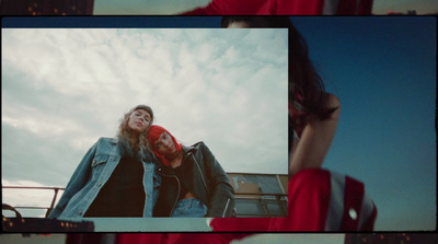 a woman in a red dress and a man in a denim jacket