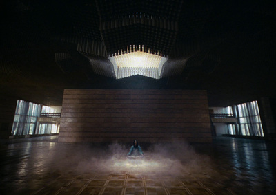 a person sitting on a bench in a room