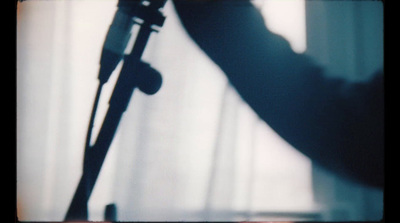 a shadow of a person holding a guitar