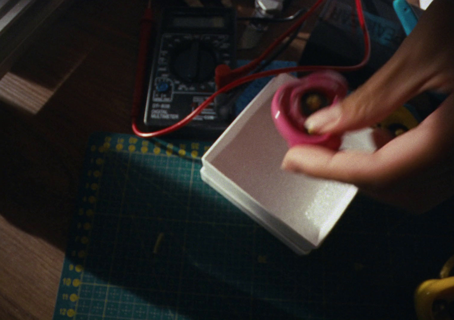 a person cutting a piece of paper with a pair of scissors