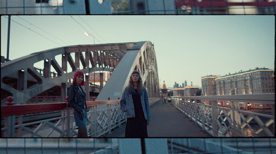 a couple of people standing on a bridge