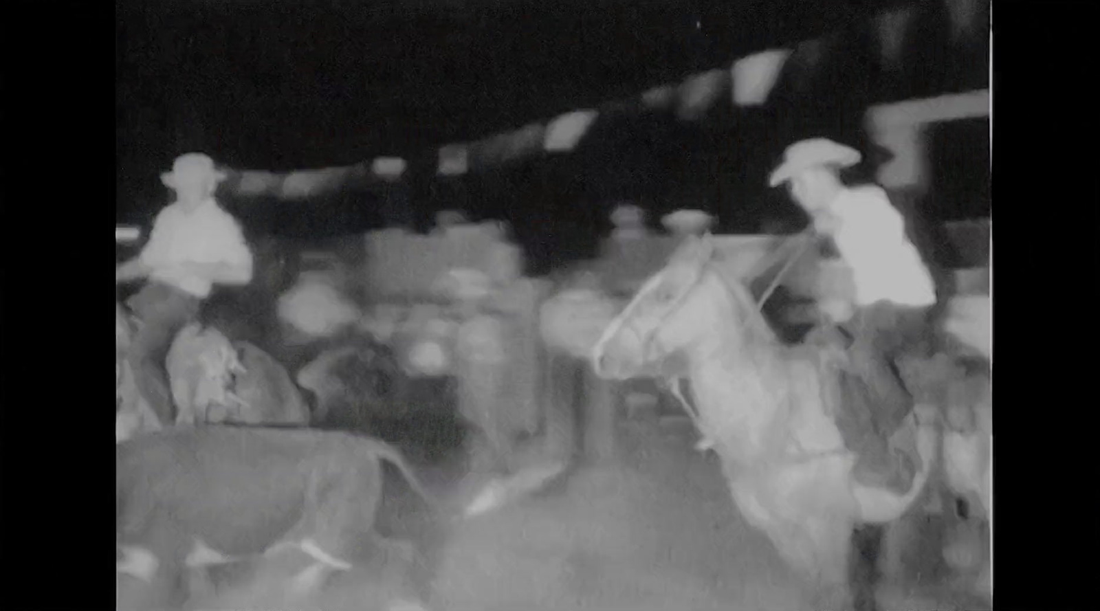 a black and white photo of a man riding a horse