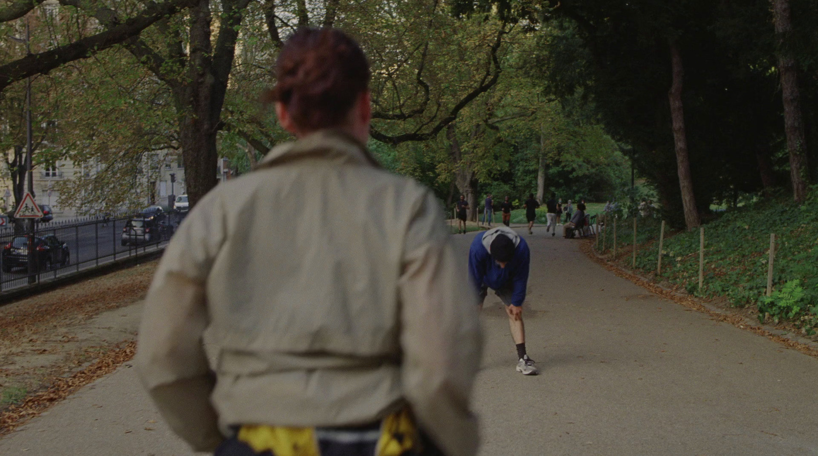 a person running down a path in a park