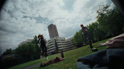 a group of people standing on top of a lush green field