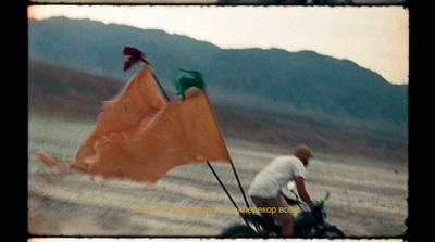 a man riding a horse pulling a kite