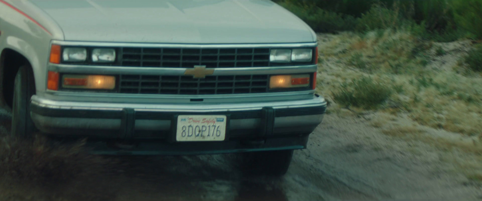 a silver truck parked on a dirt road