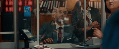 a man sitting at a desk in front of a window