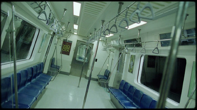 the inside of a subway car with blue seats