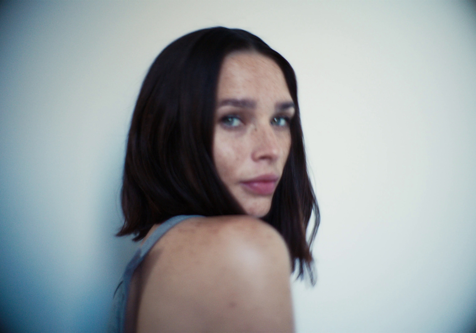 a close up of a person wearing a tank top