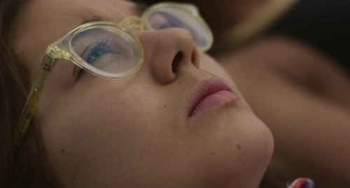 a close up of a person wearing glasses