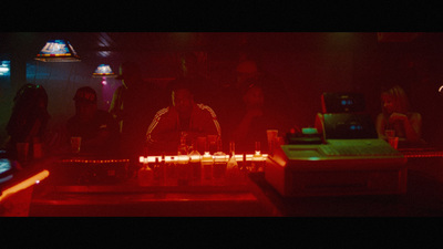 a group of people standing around a table with candles on it