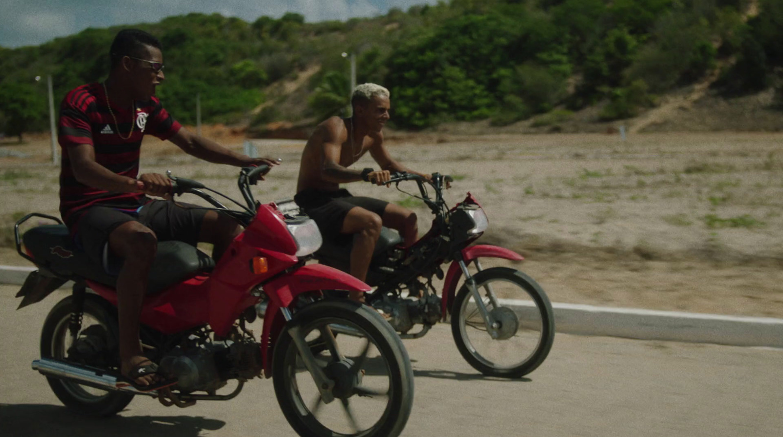 a couple of men riding on the back of motorcycles