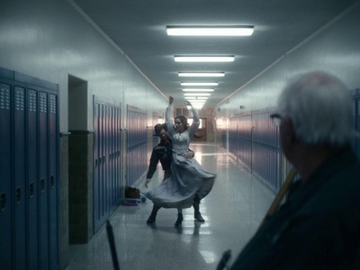 a man and a woman dancing in a hallway