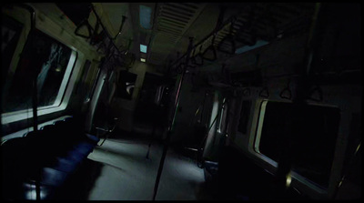 a dimly lit train car with its doors open