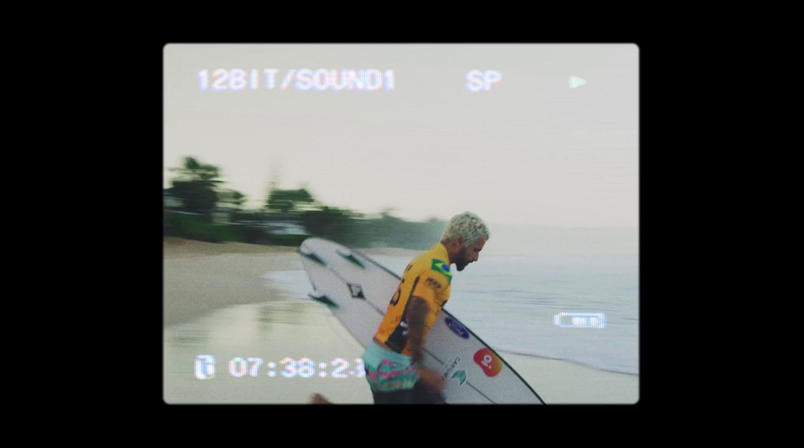 a man holding a surfboard on a beach