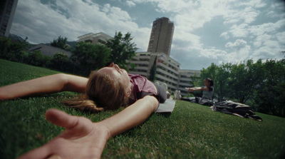 a person laying in the grass with a laptop