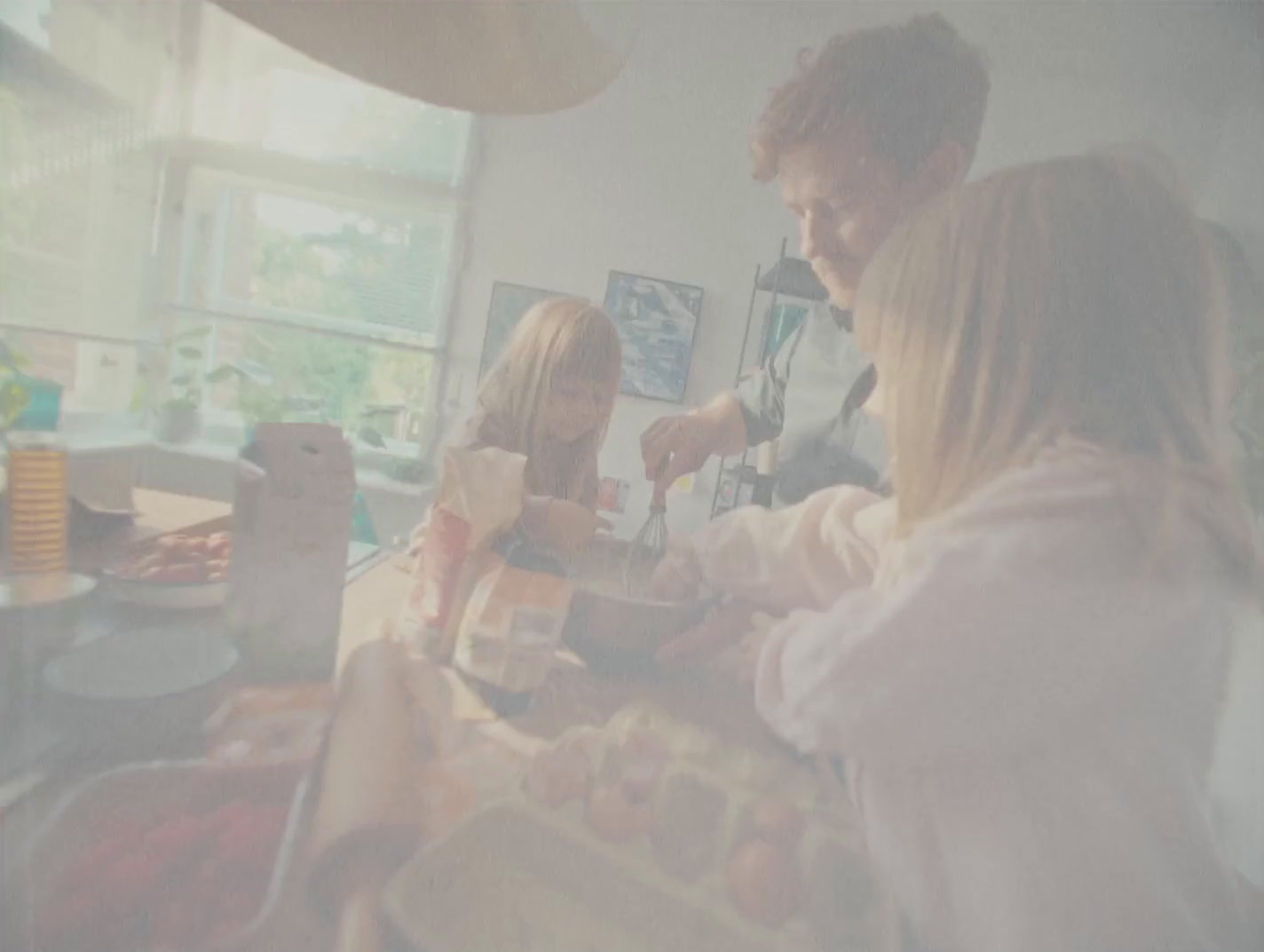 a group of people standing around a kitchen counter