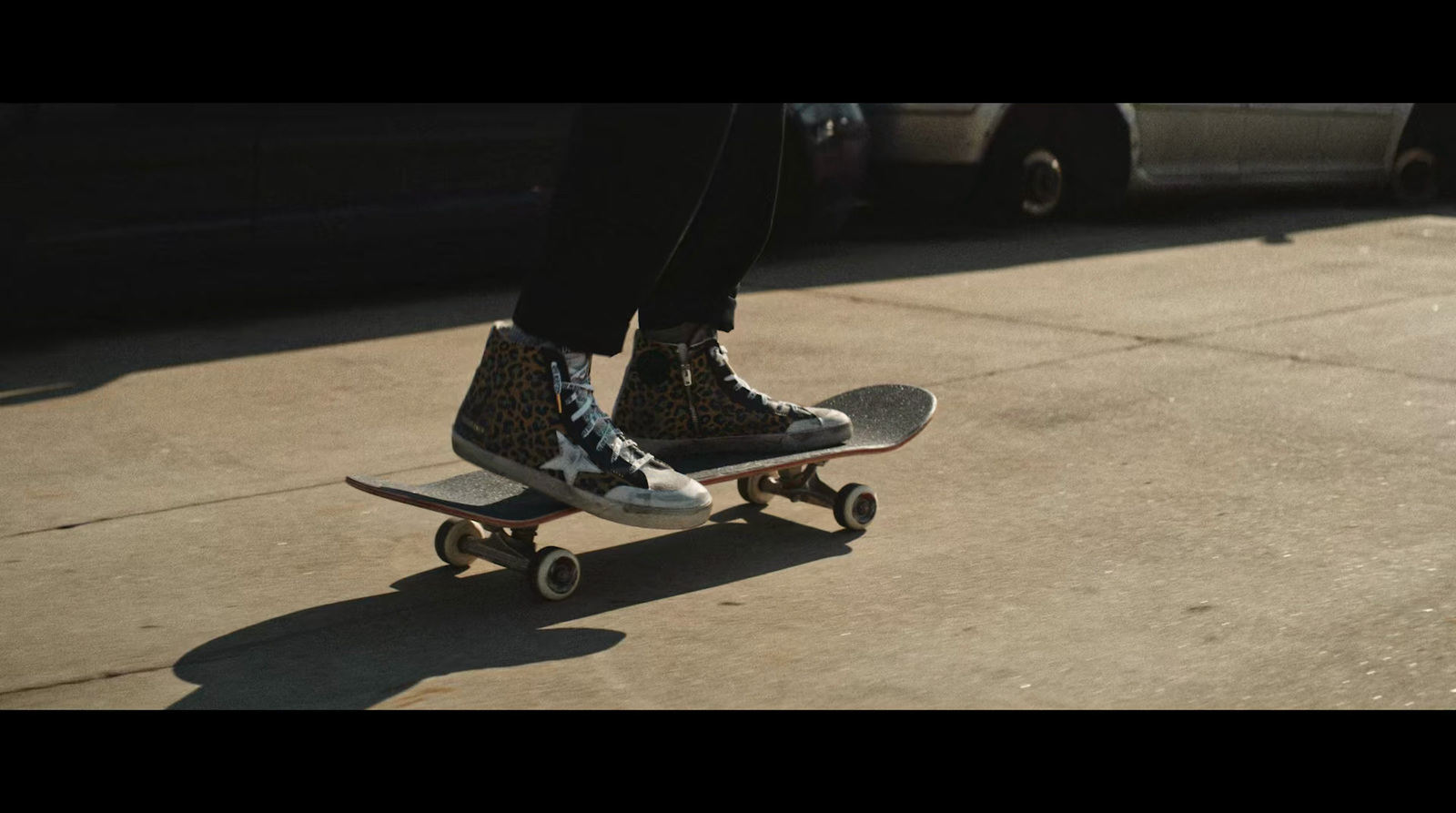 a person riding a skateboard on a sidewalk