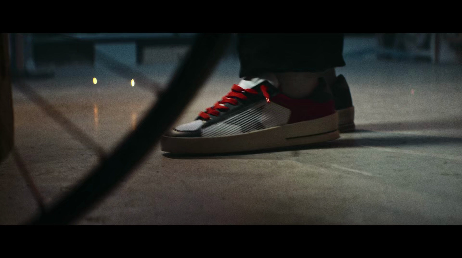 a person's feet with red and white sneakers