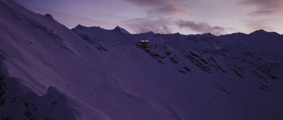 a train traveling down a snow covered mountain side