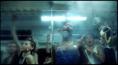 a group of people standing around a mirror