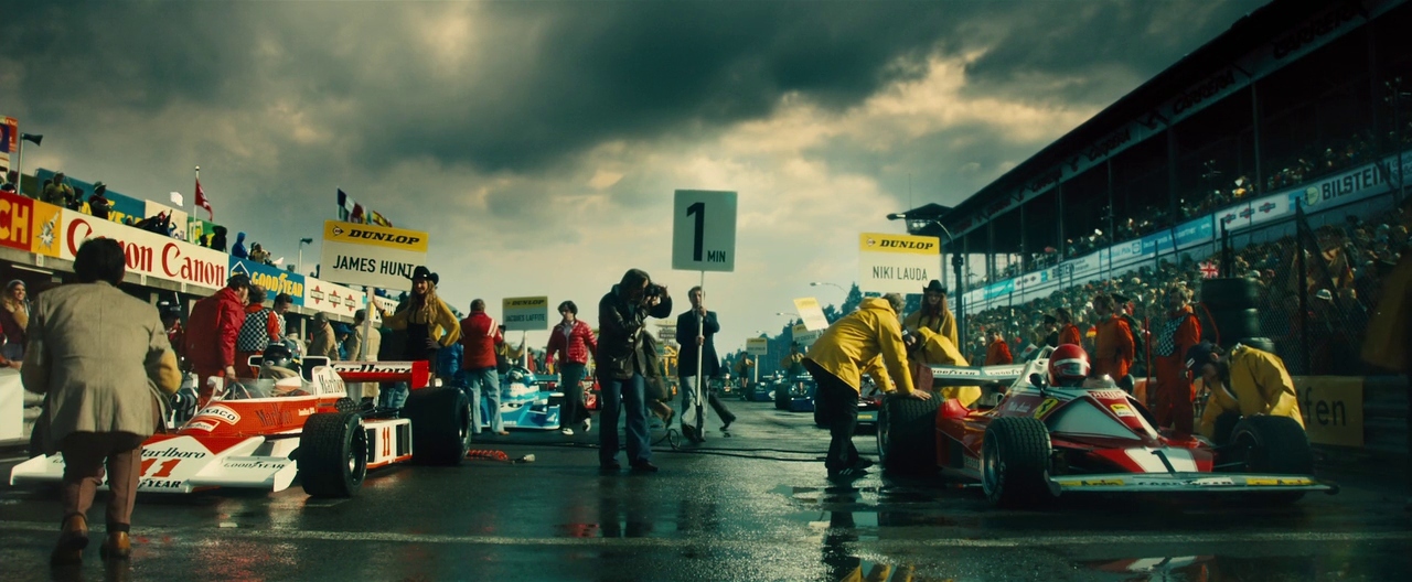 a group of people standing around a race car