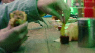 a blurry photo of a person eating a sandwich