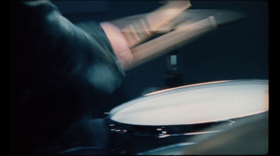 a blurry photo of a person playing drums