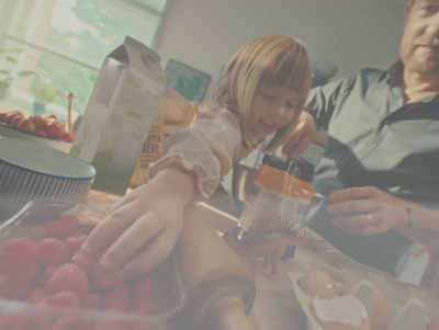 a man and a little girl are making a smoothie