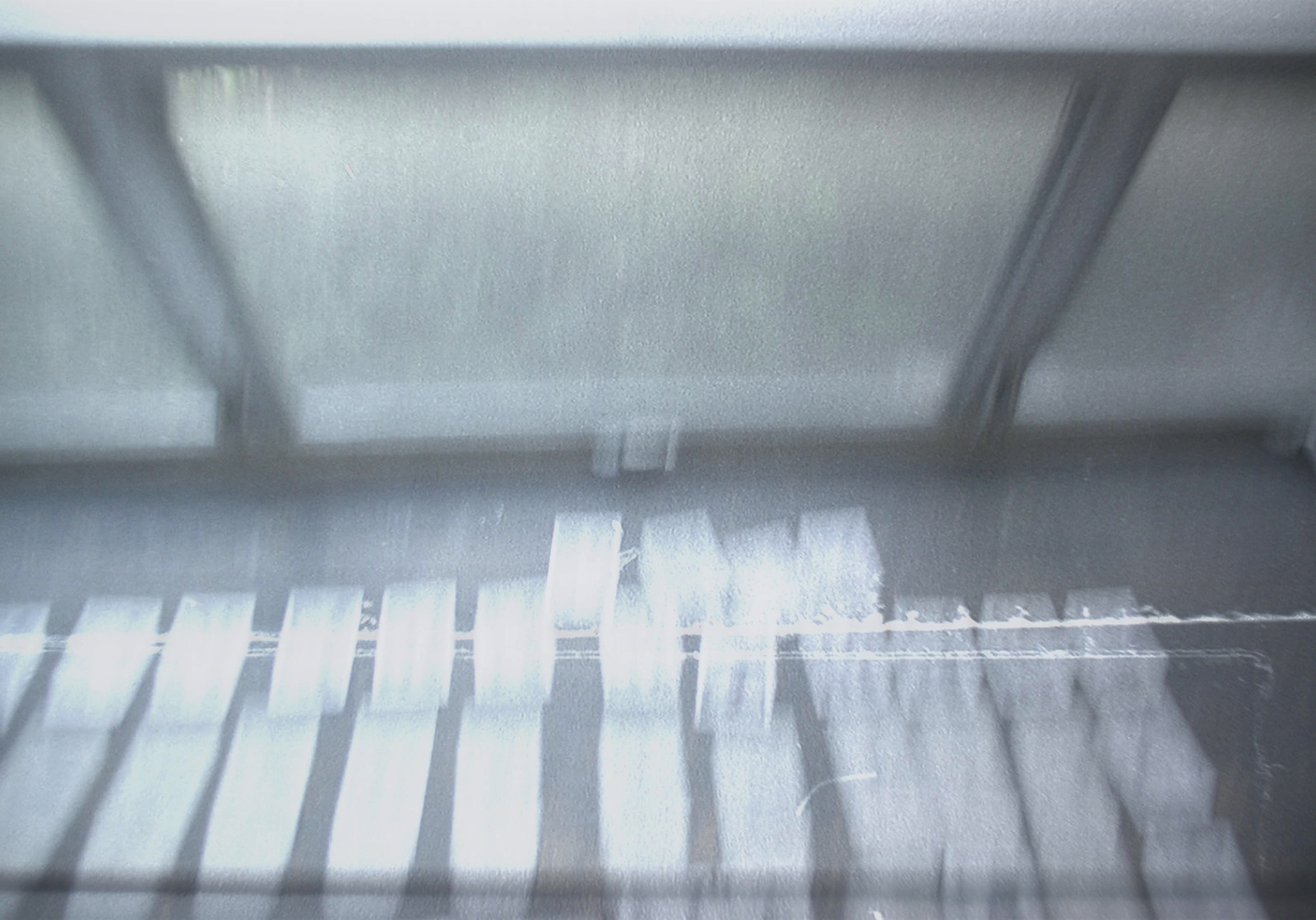 a close up of a metal shelf with a blurry background