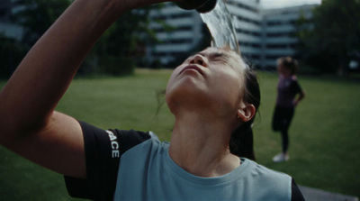 a woman drinking water out of a bottle