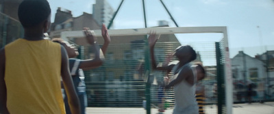 a group of young people playing a game of basketball