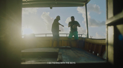 a couple of men standing on top of a boat