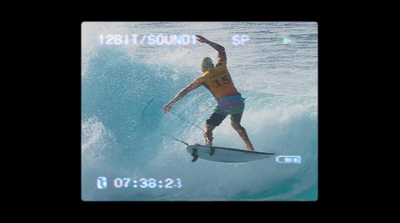 a man riding a wave on top of a surfboard