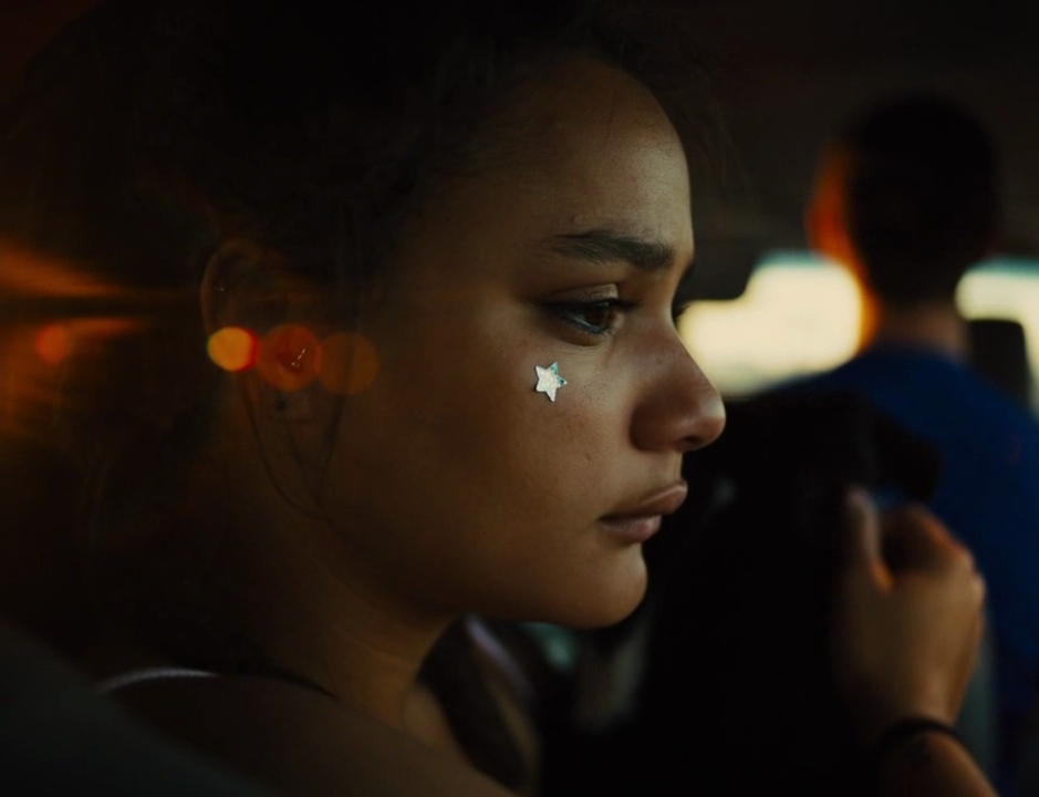 a woman with a nose piercing in a car