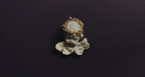 a small figurine of a baby with a crown on it's head