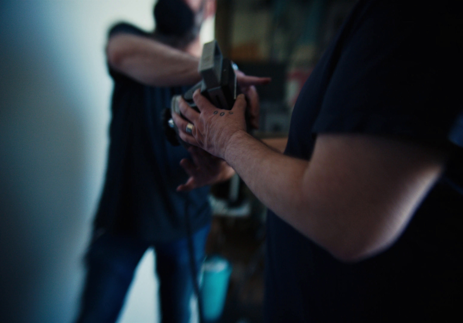 a man holding a gun in his right hand