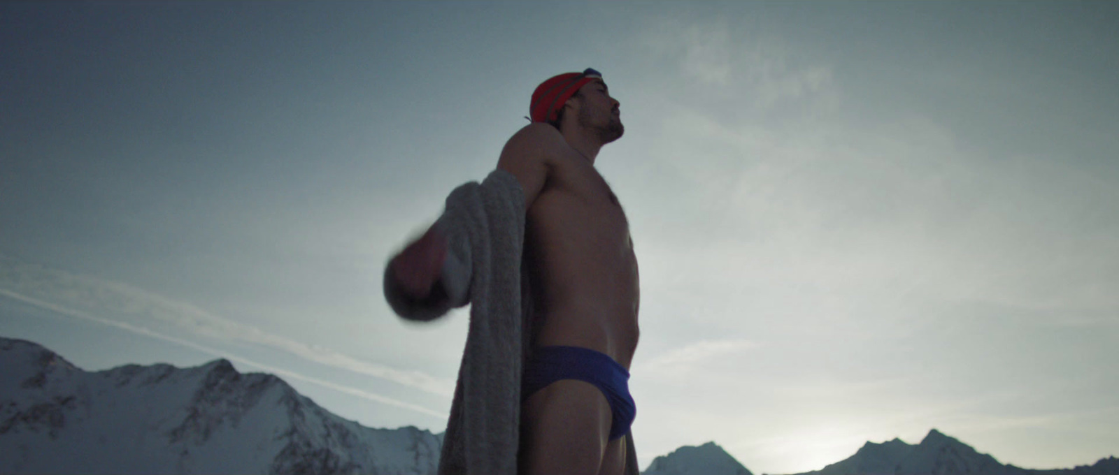 a man in a bathing suit holding a towel