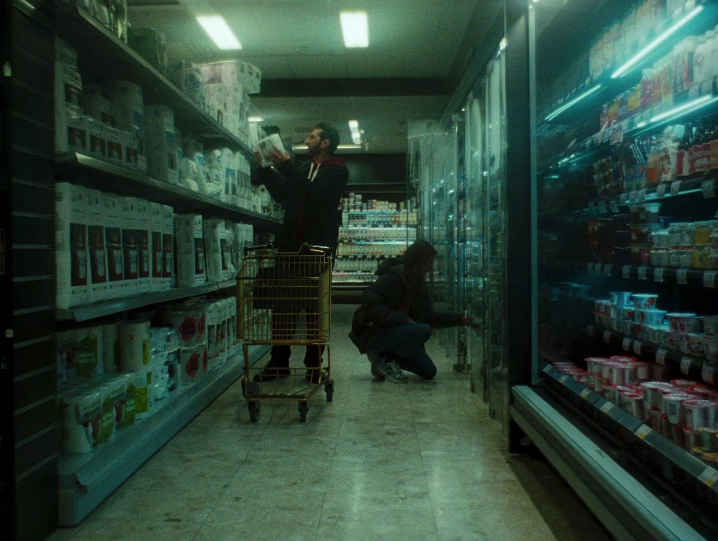 a man pushing a shopping cart through a grocery store