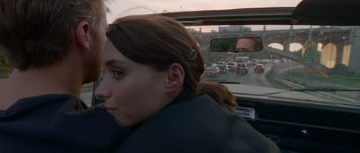 a man and a woman sitting in a car