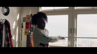 a woman standing in front of a window