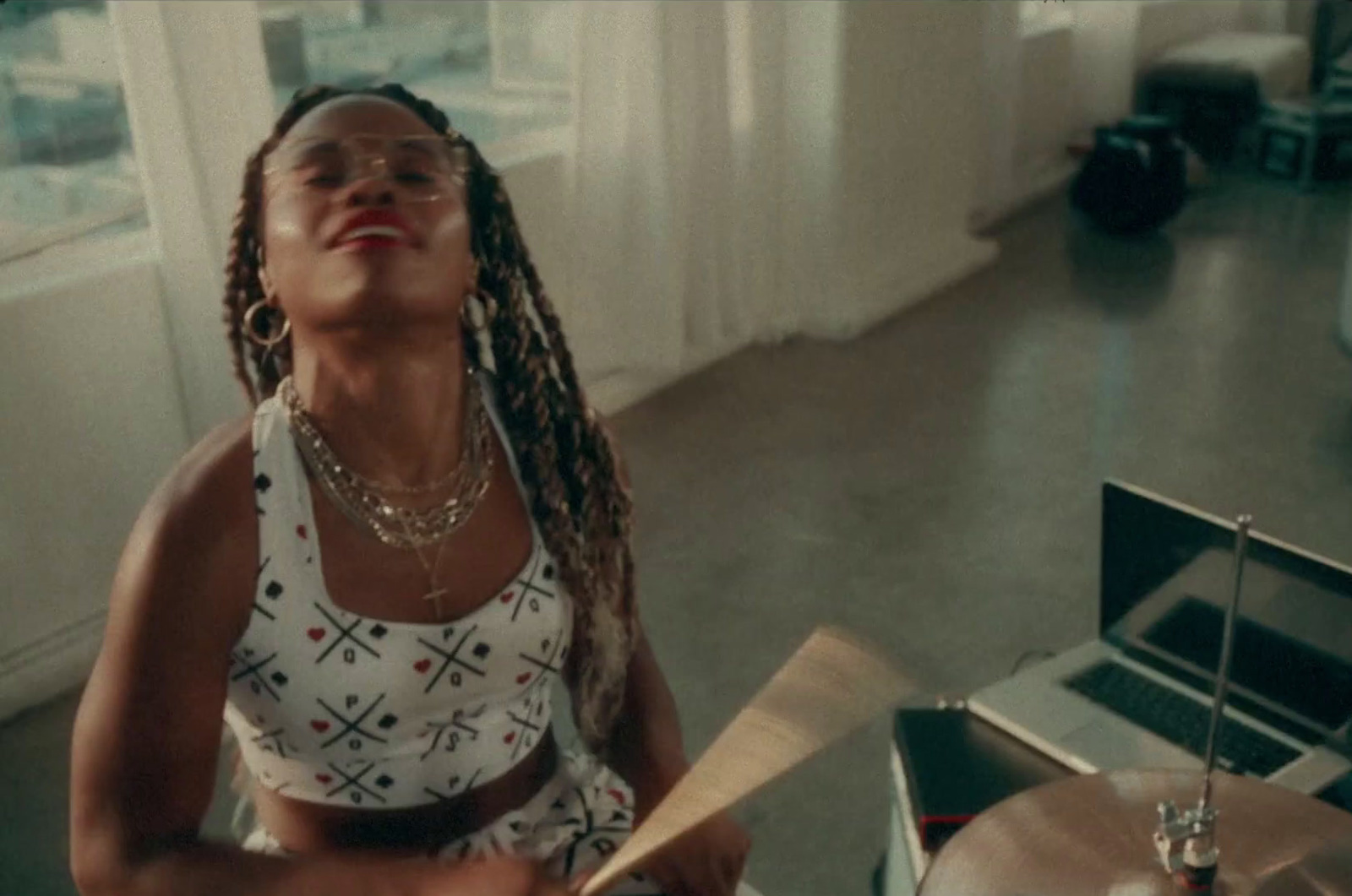 a woman with dreadlocks standing next to a record player