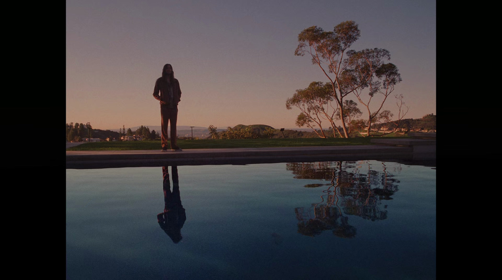 a person standing in front of a swimming pool