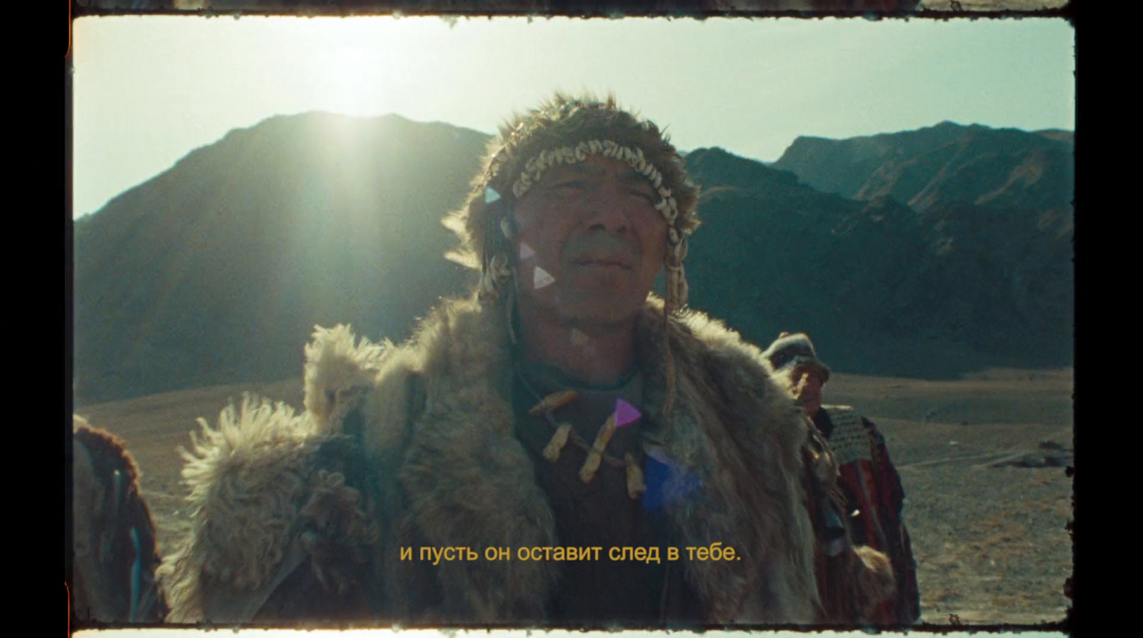 a man in a costume standing in front of a mountain