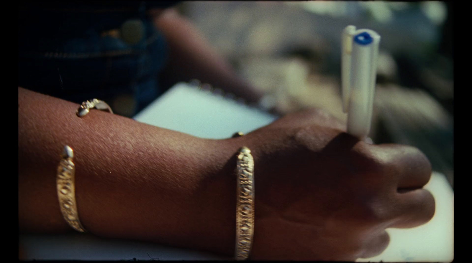 a close up of a person's arm with two bracelets on it