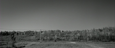 a black and white photo of a dirt road